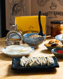Folded gyoza in the foreground with mise en place in the background