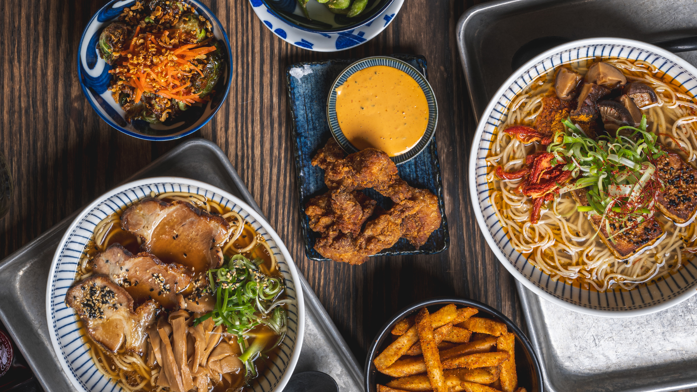 Full table with ramen bowls and sides