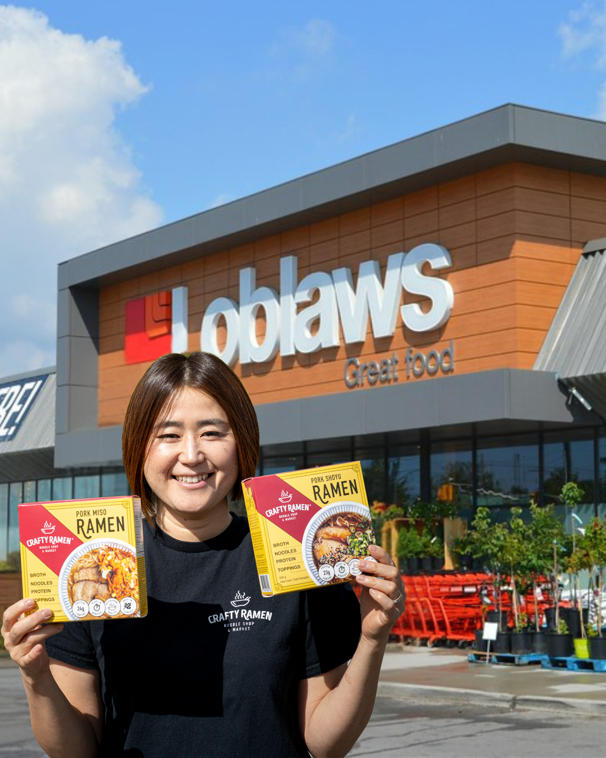 Miki standing outside in front of a Loblaws store, holding two boxes of Crafty Ramen Pork Miso Frozen Ramen and Pork Shoyu Frozen Ramen.