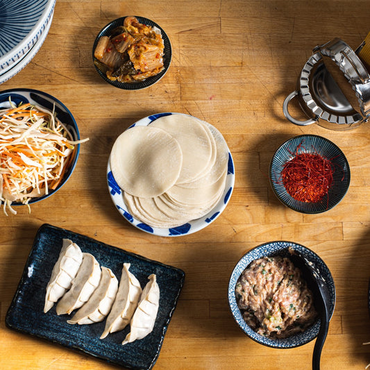 Top down view of folded gyoza and mise en place